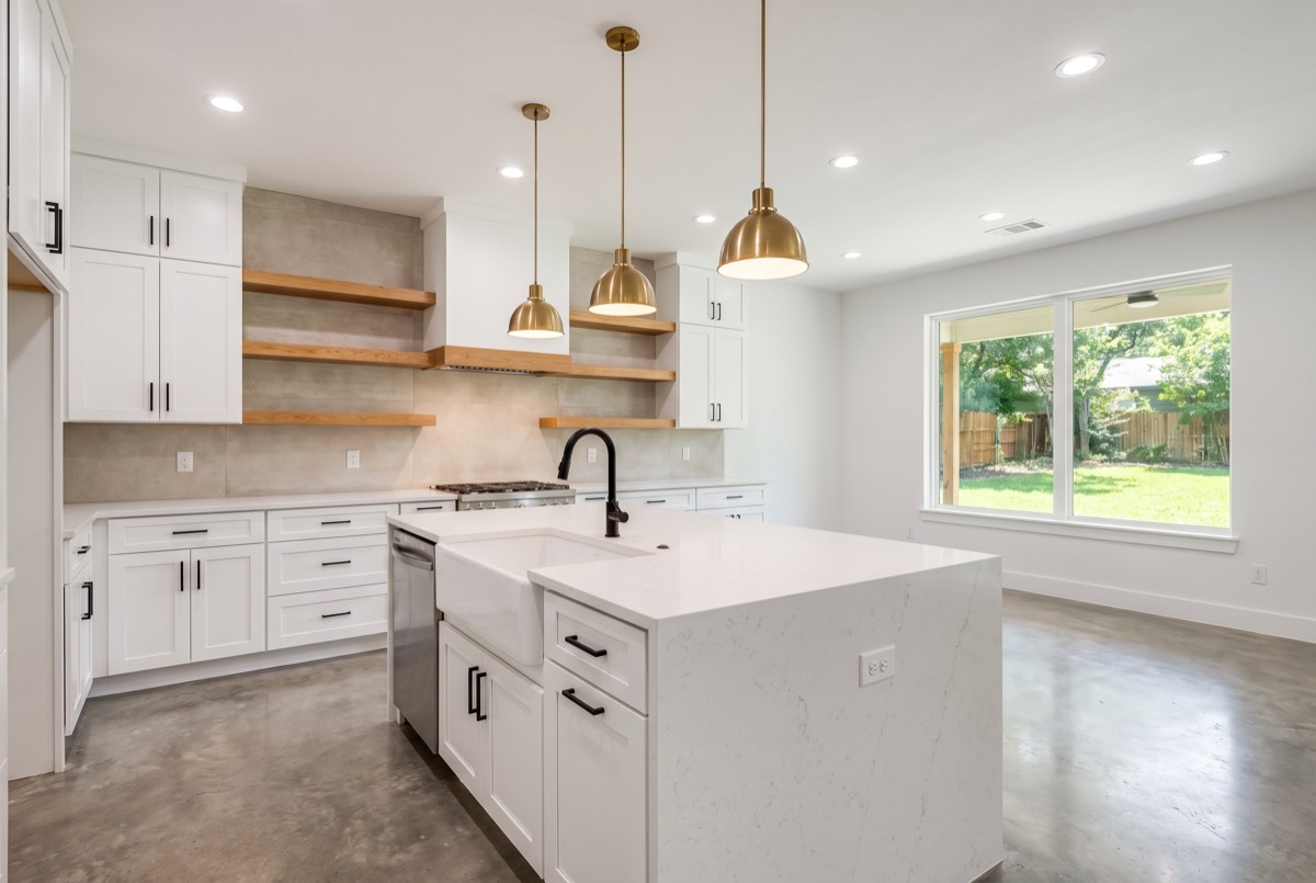 A completed kitchen with an island and pendant lighting