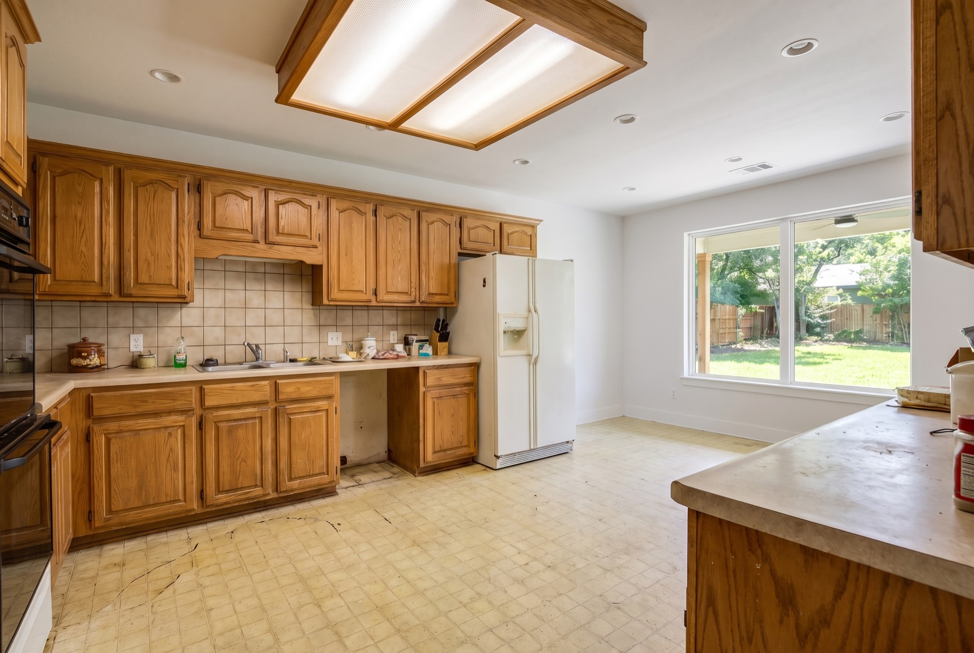 A dated kitchen with oak cabinets and laminate counters before remodeling