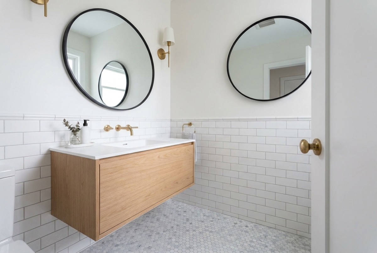 A compact remodeled guest bathroom with a floating vanity